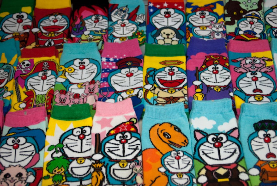 A shop display of dozens of colourful Doraemon-patterned socks.