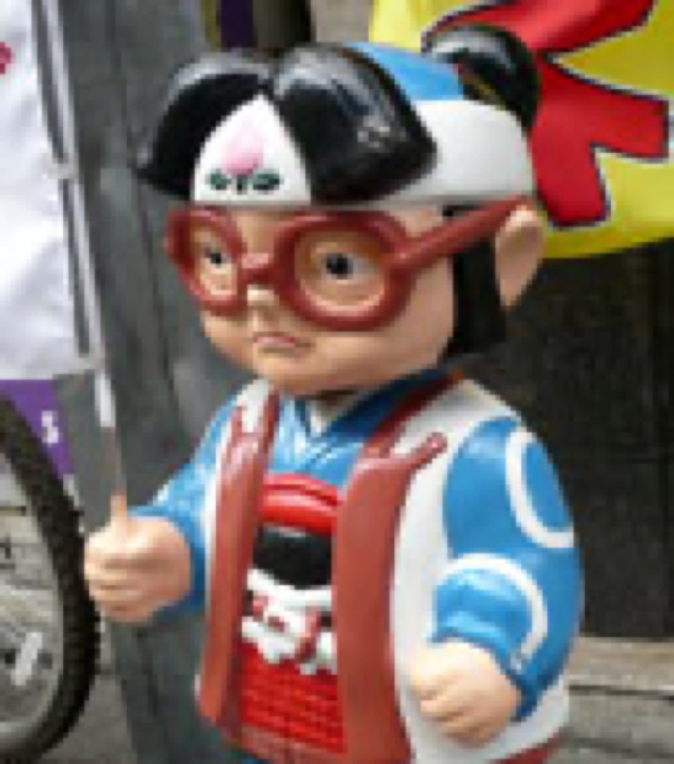 Momo-chan, a boy mascot in a samurai-style outfit and oversized red glasses.